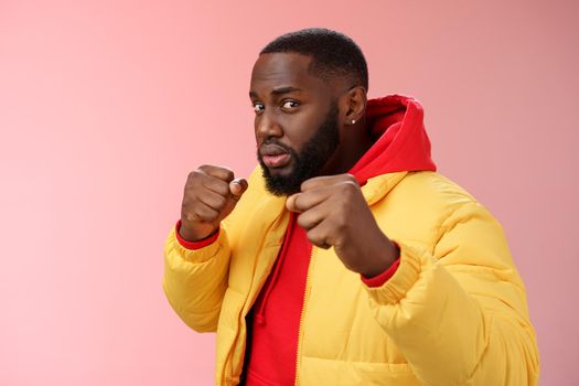 Better not mess me. Portrait serious-looking strong african-american boyfriend stand for girlfriend raising fists ready defend boxing pose wanna punch offender, standing pink background.