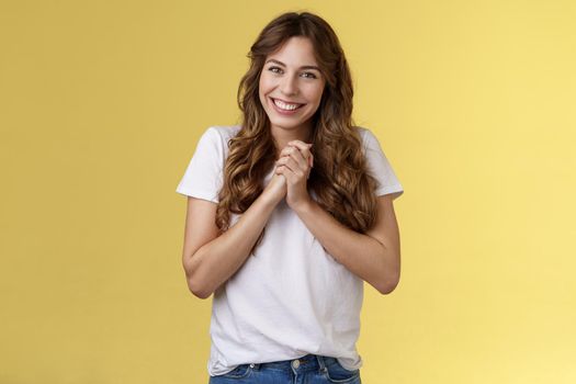 Cute lovely silly attractive female coworker appreciate friends farewell party office clasp hands thanking everyone awesome event smiling broadly delighted love adore you stand yellow background. Lifestyle.