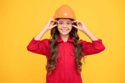 happy teenager girl in protective eyeglasses and helmet, engineer.