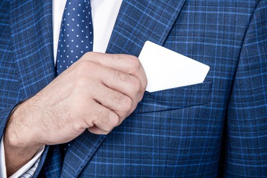 Business card being pulled out of formal suit pocket, contact info for copy space.