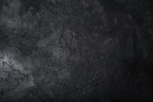 Dark textured concrete wall background. Copy space