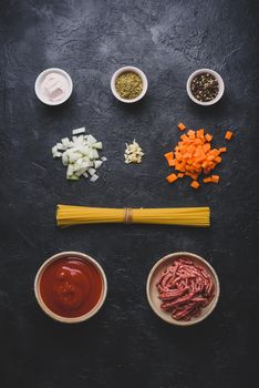 Ingredients for simple pasta bolognese on concrete background. View from above