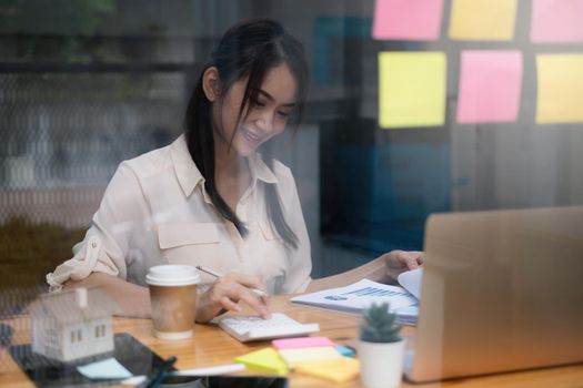 A businesswoman examines a financial chart in order to make arrangements. Investment concept for a business fund