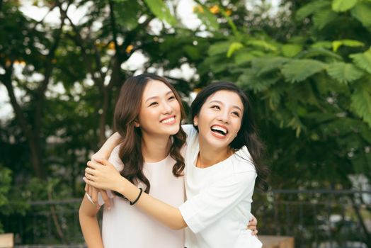 young pretty girlfriends over nature background, in the garden