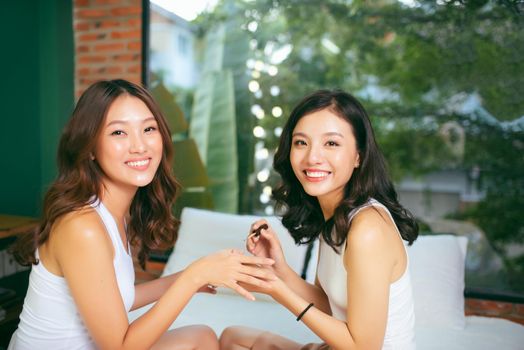 Two female friends do a manicure. The concept of hand care.