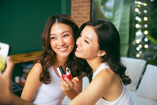 Closeup photo of cute funny girls holding varnish