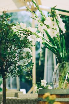 Floral wedding decoration in a restaurant outdoors in summer.