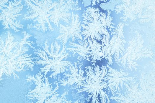 The texture of the glass covered with frost in winter in cold weather. Abstract natural background.