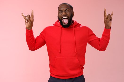 Rebellious outgoing good-looking energized african-american bearded male having fun partying show heavy metal rock-n-roll gesture stick tongue yeah enjoy awesome atmosphere music.