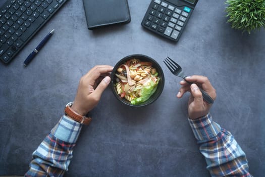 top view of bowl of fresh boiled vegetables on office desk.