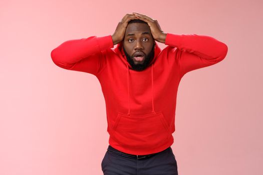 African-american man shocked speechless look upset stupor hold hands head drop jaw gazing dazed cannot believe lost all money, standing upset stunned pink background, receive terrible news.