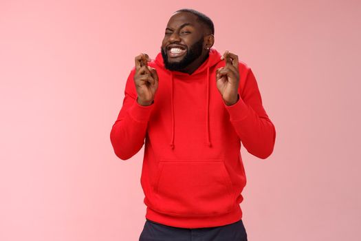 Guy hope luck cross fingers making wish hold breath excited close eyes ready meet fortune anticipating positive news thrilled playing lottery hopefully praying dream come true, pink background.