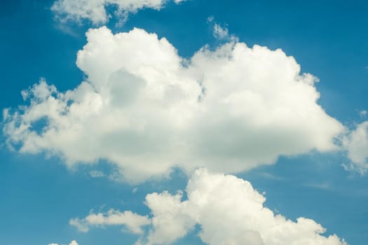 Blue sky with fluffy clouds during day time in summer.