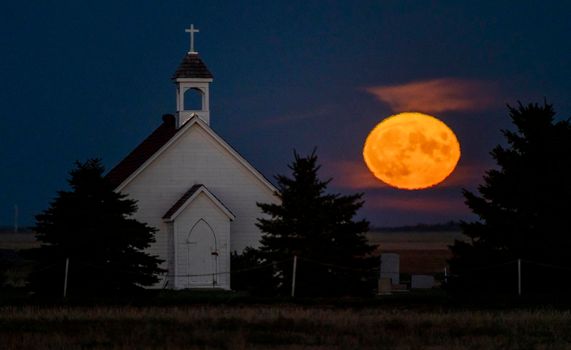 Moon rising over Prairie Country Church Canada