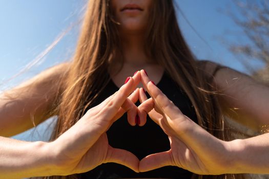 Young beautiful sportwoman practicing yoga. Coach teaching tree pose at the beach.