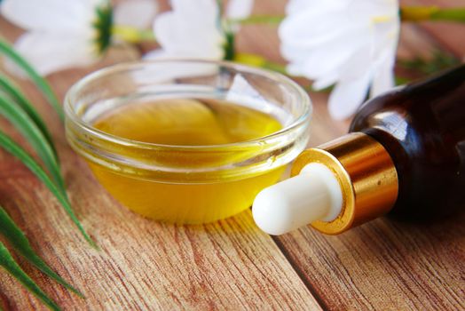 pipette and oil in a small container on table ,