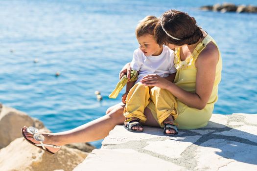 mother and son playing on the beach.