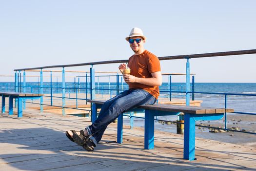 Young man holding coffee to take away at early morning.