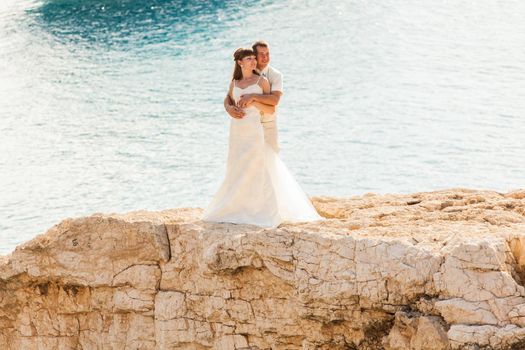 Bride and groom by the sea on their wedding day