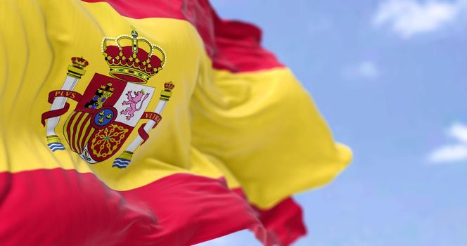 The national flag of Spain waving in the wind on a clear day. Selective focus. Realistic 3D seamless animation.