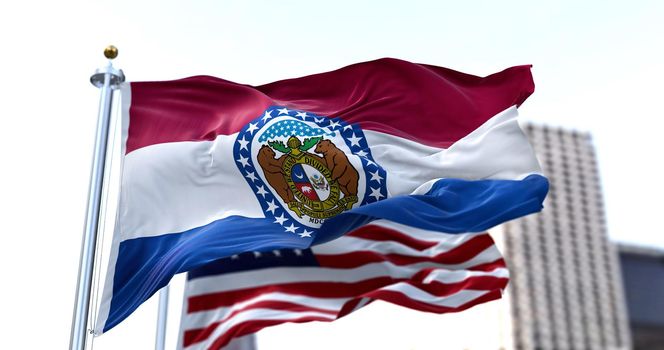 the flag of the US state of Missouri waving in the wind with the American flag blurred in the background. Missouri was admitted to the Union on August 10, 1821 as 24th state