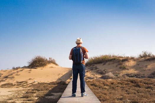 Young hipster man traveling backpacker outdoor. Travel concept