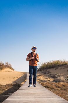 Young hipster man traveling backpacker outdoor. Travel concept