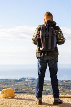 Young hipster man traveling backpacker outdoor. Travel concept