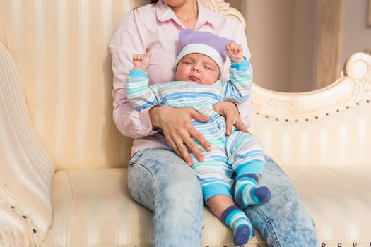 Portrait of young mother with cute baby at home.