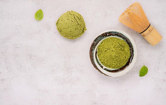 Matcha green tea ice cream with green tea powder and mint leaves  setup on white stone background . Summer and Sweet menu concept.