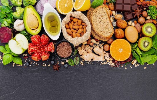 Ingredients for the healthy foods selection. The concept of healthy food set up on dark stone background.