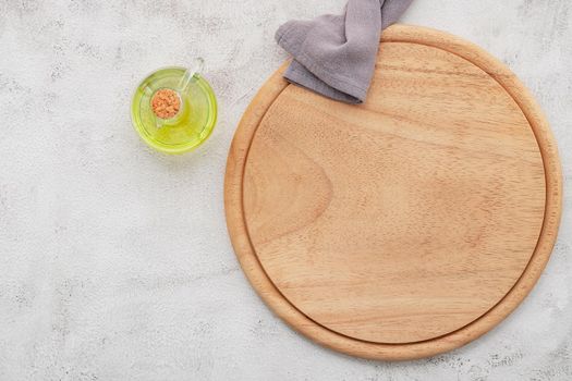 Empty wooden pizza platter set up on white concrete. Pizza board on white concrete background flat lay and copy space.