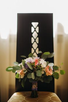 wedding bouquet with roses and boutonniere.The decor at the wedding.