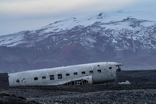 Wreck of and airplane profile against the snow covered mountains