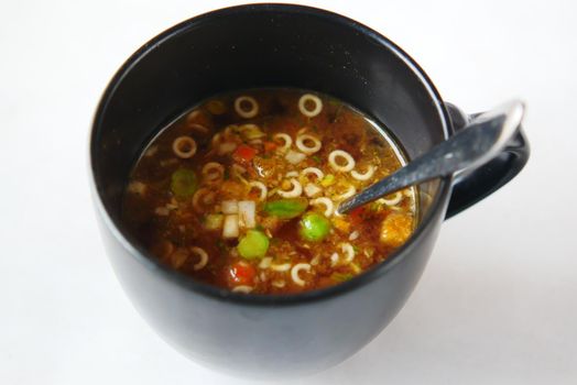 instant cup soup in a mug on table .