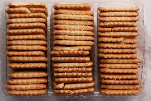 close up of cheese cookies in a packer on table .