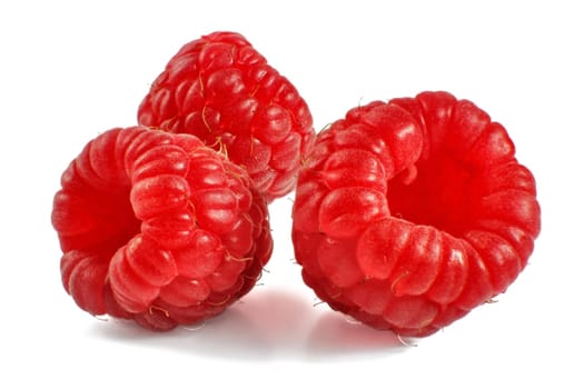 Three raspberries isolated on white background