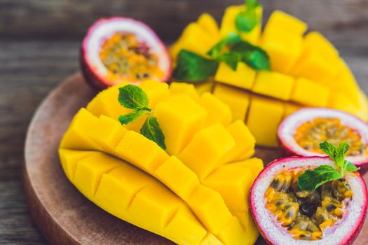 Mango and passion fruit on an old wooden background.