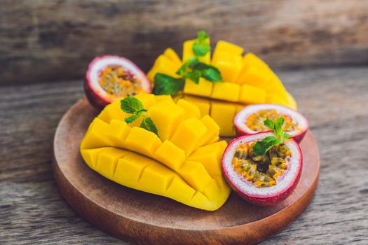 Mango and passion fruit on an old wooden background.