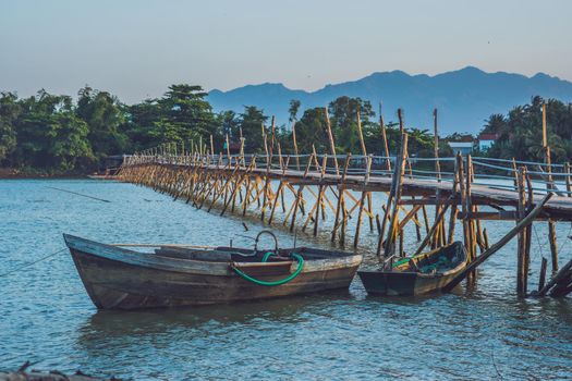 Old wooden bridge and wooden boat in Vietnam.