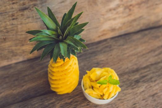 Pineapple and pineapple slices on an old wooden background.