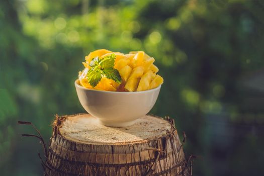 pieces of pineapple on a background of greenery.