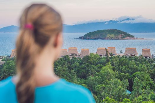 A young woman looks at the sea. Focus on the sea.