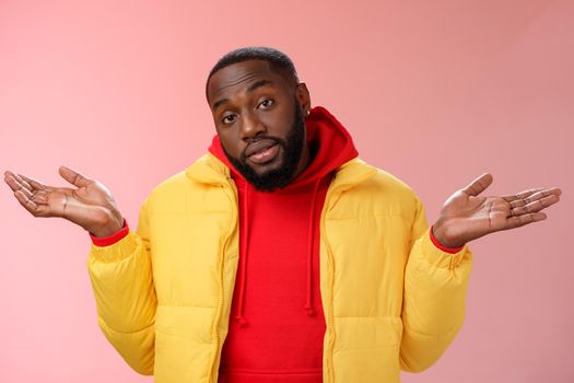 Indoor shot black bearded 25s guy shrugging hands raised sideways dismay clueless gesture have no idea standing careless questioned unaware what happened unbothered pink background. Copy space