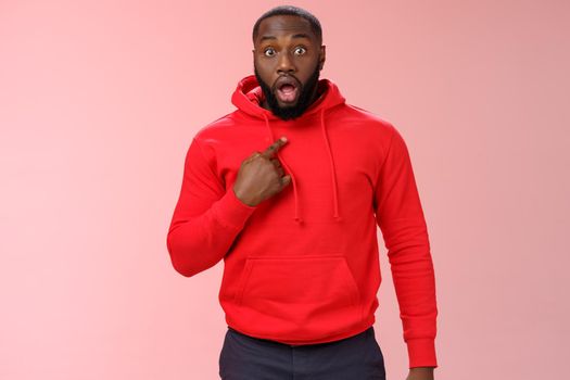 Shocked guy cannot believe he chosen drop jaw widen eyes staring camera speechless pointing himself impressed cannot believe picked do important task, standing stunned pink background.