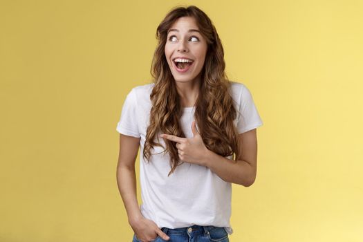 Funny amused cute girlfriend enjoy awesome party having wonderful time spend amazing day city fair open mouth surprised fascinated observe admiration lgbtq pride parade happy yellow background. Lifestyle.