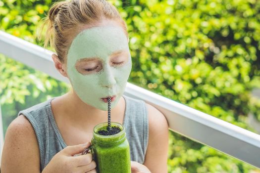 Spa Woman applying Facial green clay Mask. Beauty Treatments. Fresh green smoothie with banana and spinach with heart of sesame seeds. Love for a healthy raw food concept. Detox Concept.