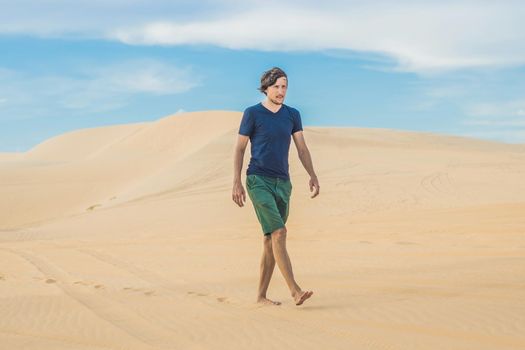 A man is walking in the desert Vietnam, Mui Ne.