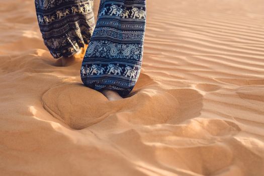 young woman in rad sandy desert at sunset or dawn