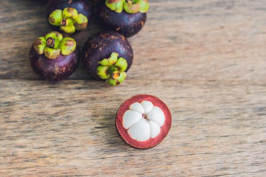 Mangosteen fruit on old wooden table. Tropical Fruits.